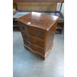 A yew wood serpentine chest of drawers