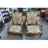 A pair of French Louis XV style carved walnut and tapestry upholstered fauteuils