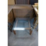 A teak and glass topped coffee table and teak chest of drawers