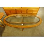 An oval glass top coffee table