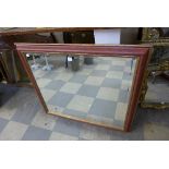 A red and parcel gilt framed mirror
