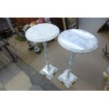 A pair of marble and cast iron stands