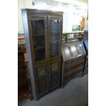 A carved oak freestanding corner cupboard and an oak bureau