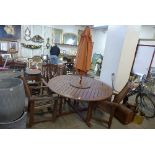 A circular wooden garden table, four chairs,