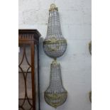 A pair of gilt metal and crystal glass wall lights