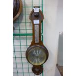 An oak aneroid barometer by Comitti of London