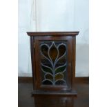 A small mahogany and stained glass wall cabinet