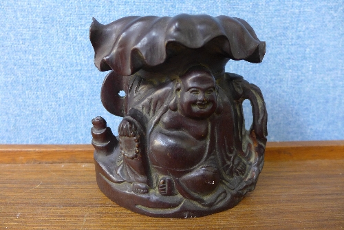 A Chinese carved wood Buddha vase