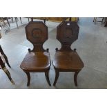 A pair of Regency mahogany hall chairs