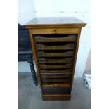 A mahogany tambour front filing cabinet