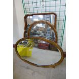 Two Victorian walnut framed mirrors and an Edward VII inlaid mahogany framed oval mirror