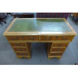 A reproduction yew wood pedestal desk with two frieze drawers over two flights of three drawers