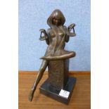 A French Art Deco style model of a girl on a black marble plinth