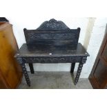 A Victorian Jacobean Revival carved oak hall table