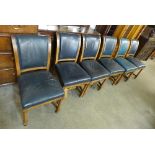 A set of seven Victorian walnut library chairs