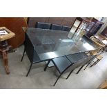 A German Bacher Tische glass topped dining table and eight Italian Calligaris Quadra black leather