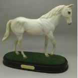 A Beswick model of Desert Orchid on a wooden base