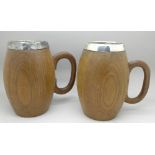 A pair of turned wooden mugs with silver plated lining