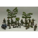 Britains and other lead soldiers, a Dinky Toys motorbike and sidecar, two trees, etc.