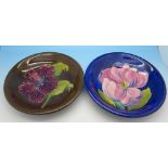 Two Moorcroft dishes including hibiscus with brown background,