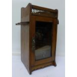 An oak smoker's cabinet,