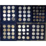 Two boxes containing six trays of foreign coins including reproduction American and Chinese