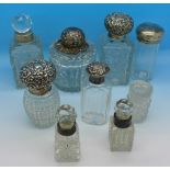 Nine bottles including eight with silver tops or collars,