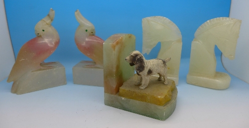 Two pairs of alabaster book ends and a single book end with spaniel