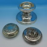 A wide silver candlestick or stand,