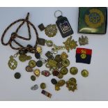 A collection of military badges, buttons, etc.