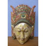 A carved and painted deity head