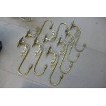 A set of eight brass wall lights