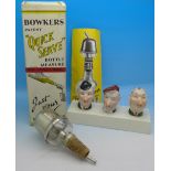 Three novelty bottle pourers including Laurel and Hardy and a 'Quick Serve' bottle measure,