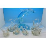 Six glass swan baskets and a glass model of a dolphin