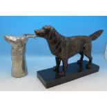 A pewter stirrup cup and a model of a dog