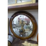 A walnut framed circular mirror