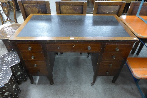 An Edward VII inlaid mahogany and leather topped desk