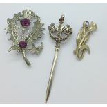 Two silver brooches and one other brooch