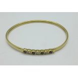 A 9ct gold and cubic zirconia bangle, 6.