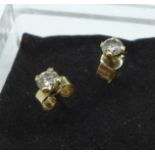 A pair of diamond stud earrings