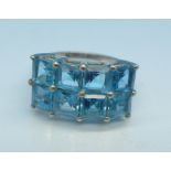 A silver and blue topaz ring,