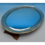 An oval silver framed mirror, 31cm x 24cm,