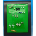 Ten pairs of silver earrings and a brooch