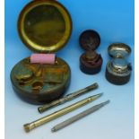 Three travel inkwells including one with stamp compartment and a roller,