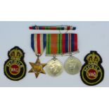 A WWII medal group with The France and Germany Star, ribbon bar and two cloth patches Mobile V.A.D.