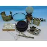 A magnifying glass, horn bangle, compact, hardstone disc on a wooden stand, etc.