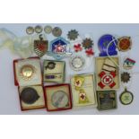 A collection of enamel and other badges including Royal Life Saving Society, ski badges, etc.