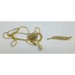 A 9ct gold brooch, a 9ct gold pig charm and a 14ct gold pendant on a yellow metal chain,