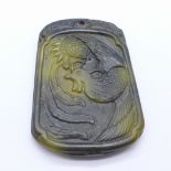 A carved pendant with bird of paradise,