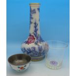 A shot glass with millefiori glass bottom, a bottle vase and a small Japanese bowl,